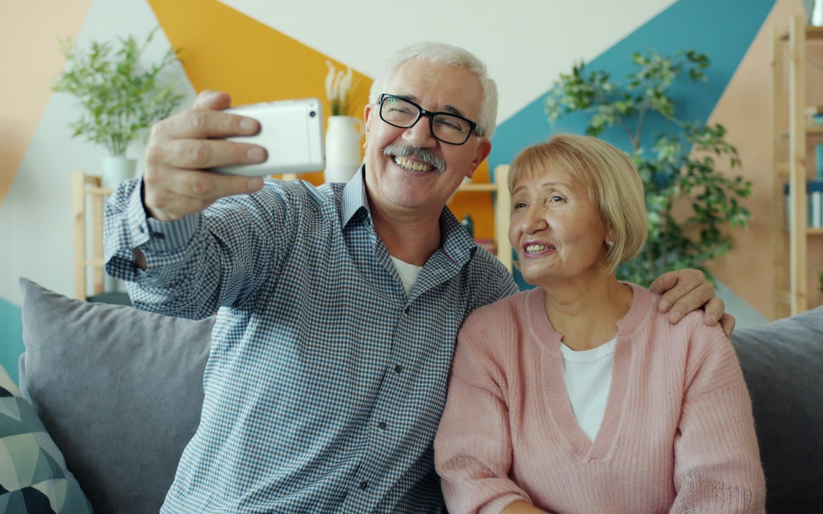 A happy older couple taking a selfie together